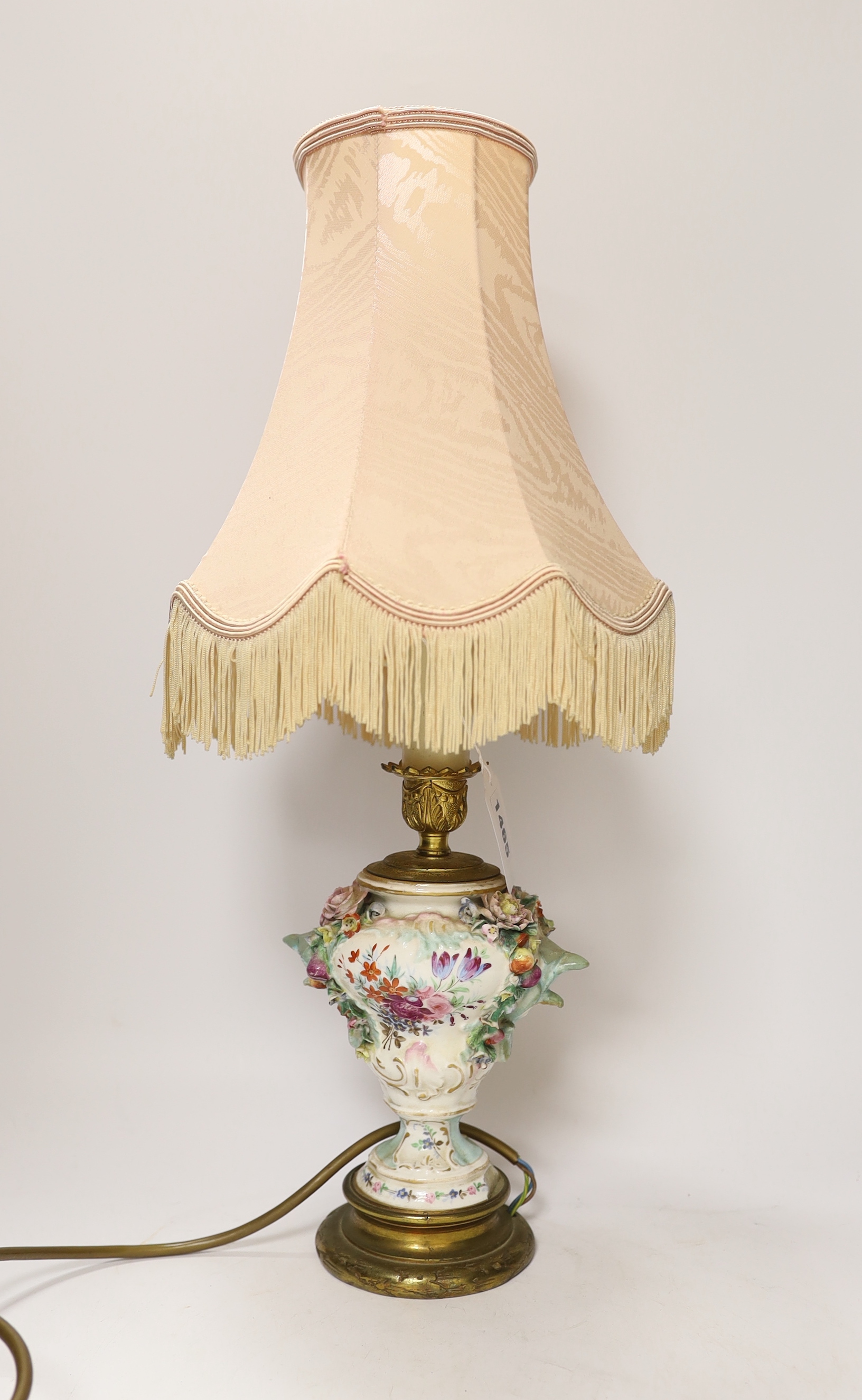 A 19th century floral encrusted table lamp with silk shade, 47cm high